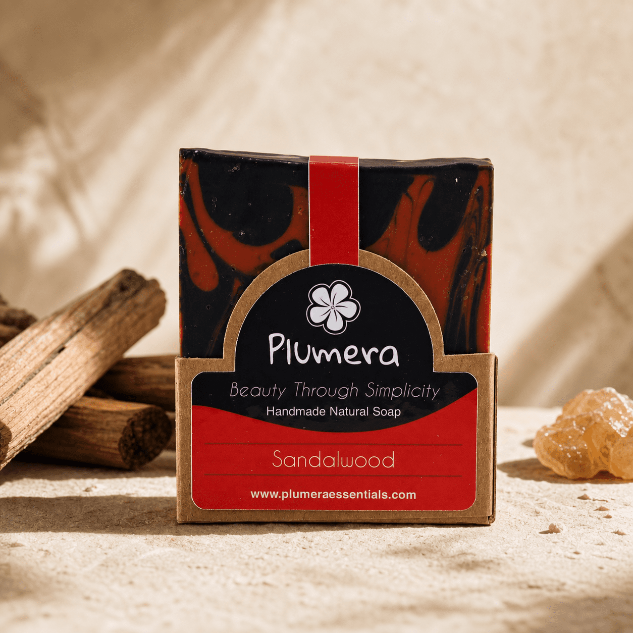 Plumera Sandalwood handmade soap with black and rust marbling in kraft packaging
